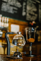 Fototapeta na wymiar Siphon vacuum coffee maker on cafe bar
