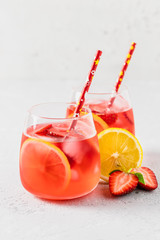 Summer iced strawberry lemon infused water cocktail. Selective focus, space for text.