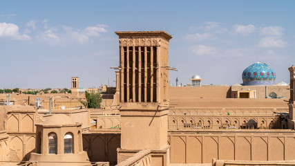 Yazd cityscape with old brick buildings and badgirs wind catching towers in Yazd, Iran.