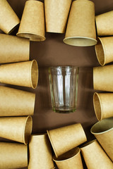 Zero waste concept. Eco-friendly, disposable, cardboard, paper dishes against glass reusable dishes. View from the top.