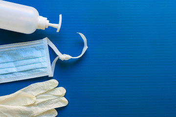 Medical mask, glove and disinfectant for corona virus on blue background