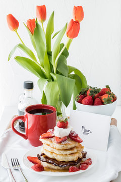 A close up of a stack of pancakes on a tray table for Mother's Day breakfast in bed. Mother's Day concept.