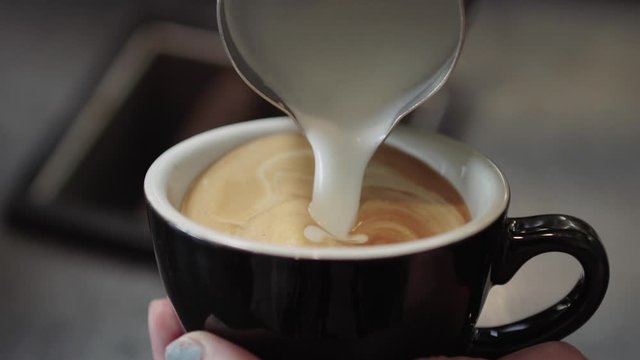 Barista Making Latte Art in Cup with Cream Slow Motion
