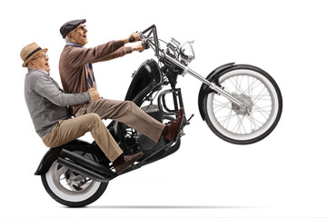 Crazy senior men riding a motorbike on one wheel