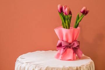 Purple tulips are on the table