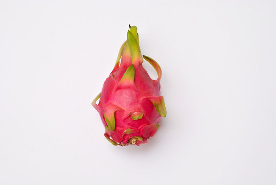 Beautiful tropical exotic dragon fruit pitahaya on the white backgroudn isolated picture top view flat lay closeup. Clolorful minimalistic fresh healthy food. Summer vacation tasty