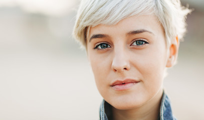 casual portrait of beautifu blond young woman outdoors