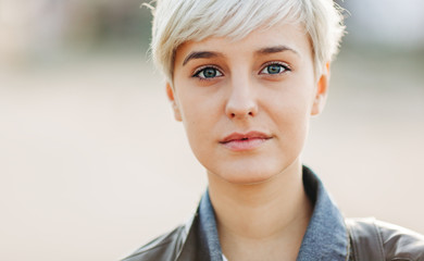 casual portrait of beautifu blond young woman outdoors