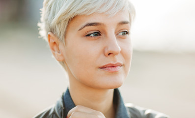 casual portrait of beautifu blond young woman outdoors