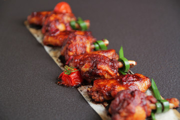  Grilled baked chicken wings with hot chili pepper and soy sauce.