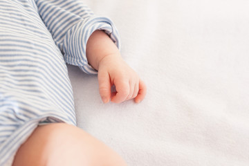 Obraz na płótnie Canvas Close-up of a baby hand.close-up hand of a baby who is sleeping. Hand of a newborn. Maternity. Children. Kid.