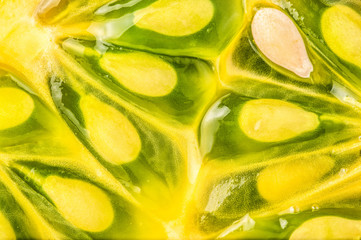 Kiwano or Horned Melon Cucumis metuliferus sliced in a half on white background