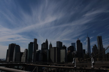 Naklejka na ściany i meble New York City Skyline with Clouds from Brooklyn Bridge Darkened