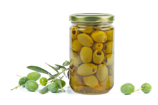 Glass jar with pickled olives, and olive branch near Isolated on white background