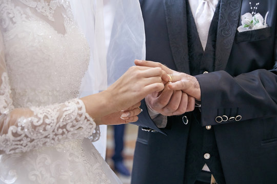 bride and groom holding hands