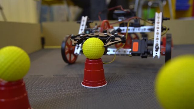 A programmed robot made of a designer performs a task on a special site.The robot should lift the block. The program does not work correctly.