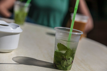 Mojito in a plastic glass -Mojito is a traditional Cuban drink made with white rum, sugar, lime juice, soda water, and fresh mint leaves
