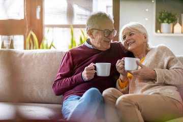 Portrait of a happy senior couple relaxing together at home  - Powered by Adobe