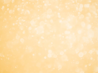 Golden background with soft bokeh lights.