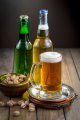 Light beer in a glass on a table in composition with accessories on an old background