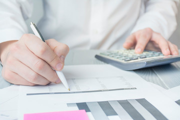 Businessman works with papers. Close-up of the hands of a working man. Work with checks, taxes and bills. Brainstorm. Business goals