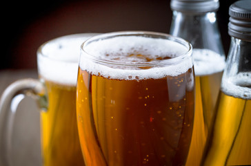 Light beer in a glass on a table in composition with accessories on an old background