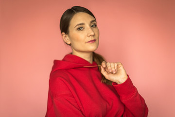 young woman in a bright red hoodie