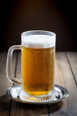 Light beer in a glass on the table