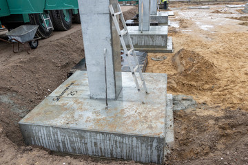 some Concrete columns for a factory building are erected on a large construction site