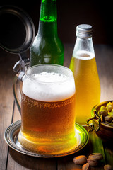 Light beer in a glass on a table in composition with accessories on an old background