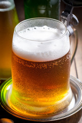 Light beer in a glass on a table in composition with accessories on an old background