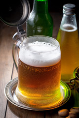 Light beer in a glass on a table in composition with accessories on an old background