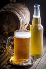 Light beer in a glass on a table in composition with accessories on an old background