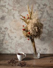 Cup of coffee and a bouquet of flowers