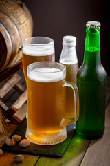 Light beer in a glass on a table in composition with accessories on an old background