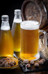 Light beer in a glass on a table in composition with accessories on an old background