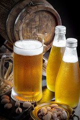 Light beer in a glass on a table in composition with accessories on an old background