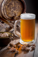 Light beer in a glass, on an old background.