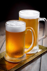 Light beer in a glass, on an old background. 