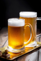 Light beer in a glass on a table in composition with accessories on an old background