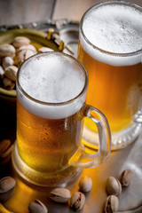 Light beer in a glass on a table in composition with accessories on an old background