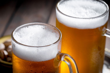 Light beer in a glass on a table in composition with accessories on an old background