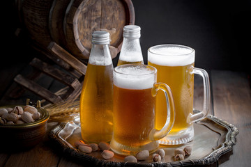Light beer in a glass on a table in composition with accessories on an old background