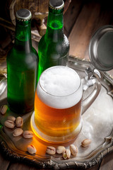 Light beer in a glass, on an old background.