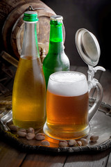 Light beer in a glass on a table in composition with accessories on an old background
