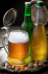 Light beer in a glass, on an old background. 