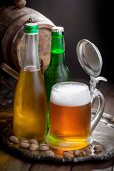 Light beer in a glass on a table in composition with accessories on an old background