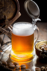 Light beer in a glass, on an old background.