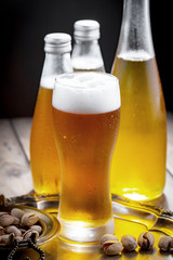 Light beer in a glass, on an old background. 