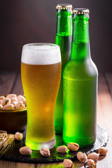 Light beer in a glass on a table in composition with accessories on an old background